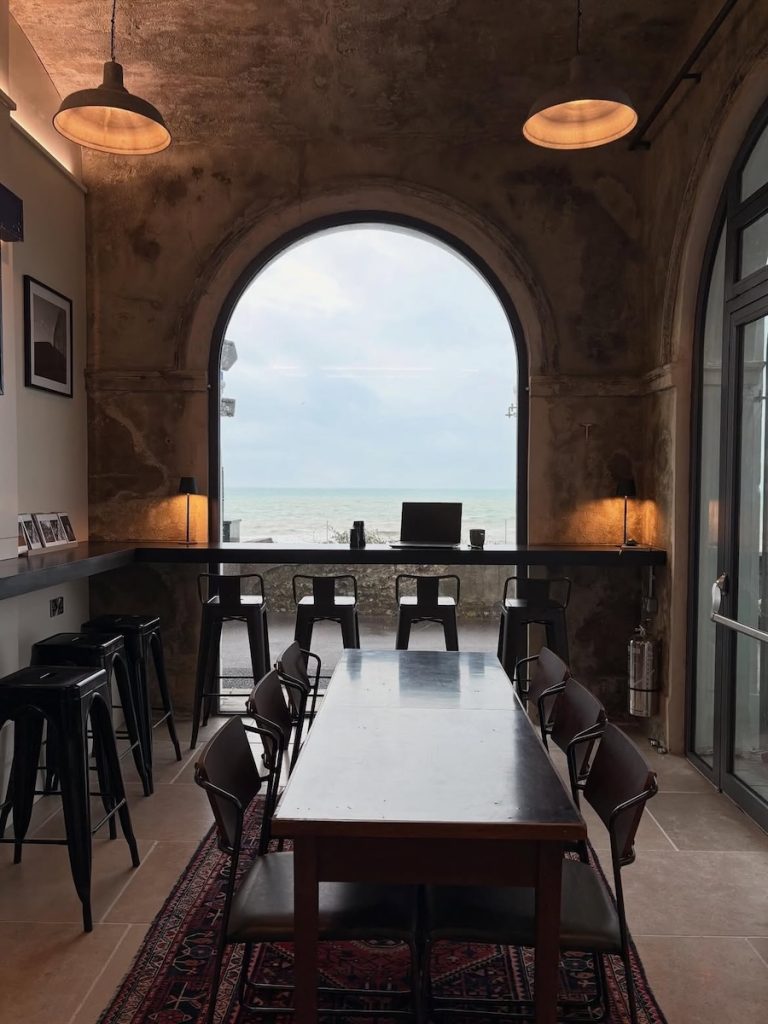 Arched window inside The Temple cafe Brighton, looking out to the sea