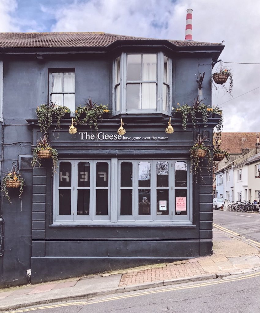 dark painted facade of a historic corner pub in Brighton