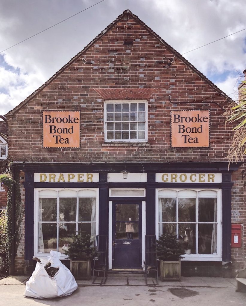 A beautifully preserved Victorian draper and grocer shop front with original Brooke Bond Tea signs in the East Sussex village of Chiddingly