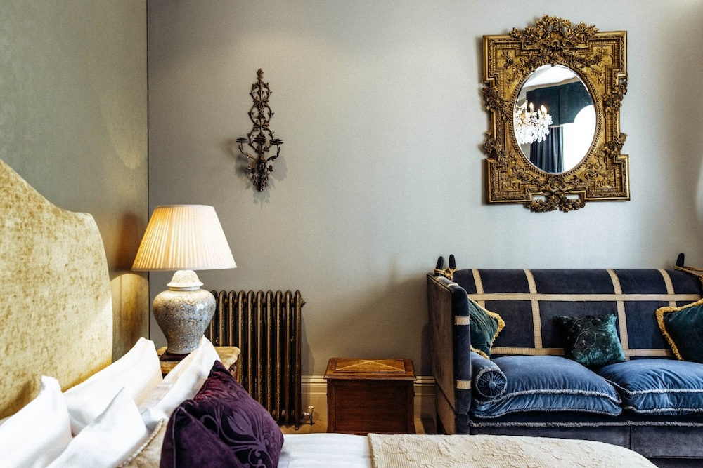 Bedroom at Blanch House Brighton with velvet sofa and ornate gold mirror