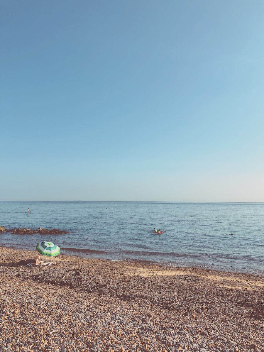 striped beach umbrella stony beach