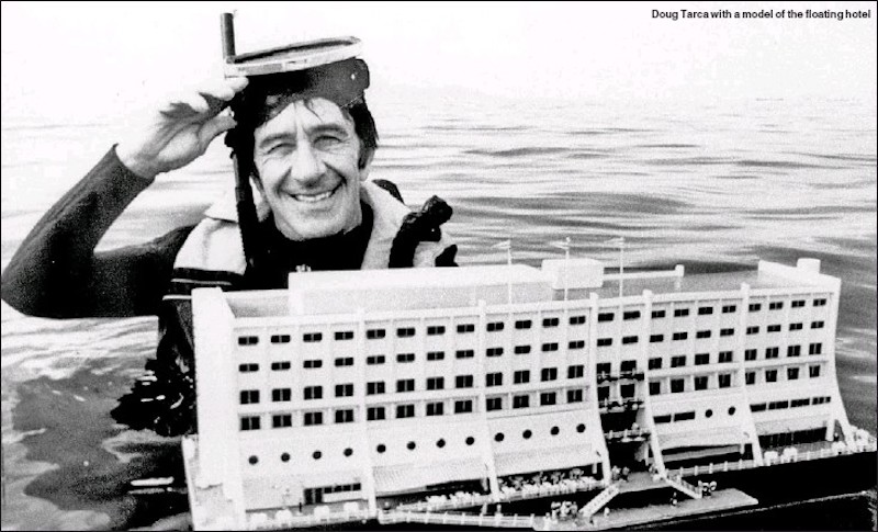 diver in sea holding model of a building
