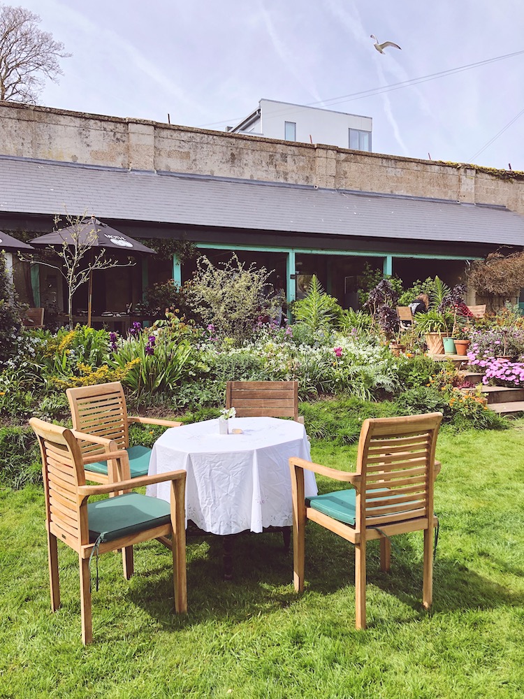 a table set for afternoon tea inside a historic walled garden in Kemptown in Brighton
