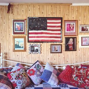 framed photos of Dolly Parton on wood panelled wall