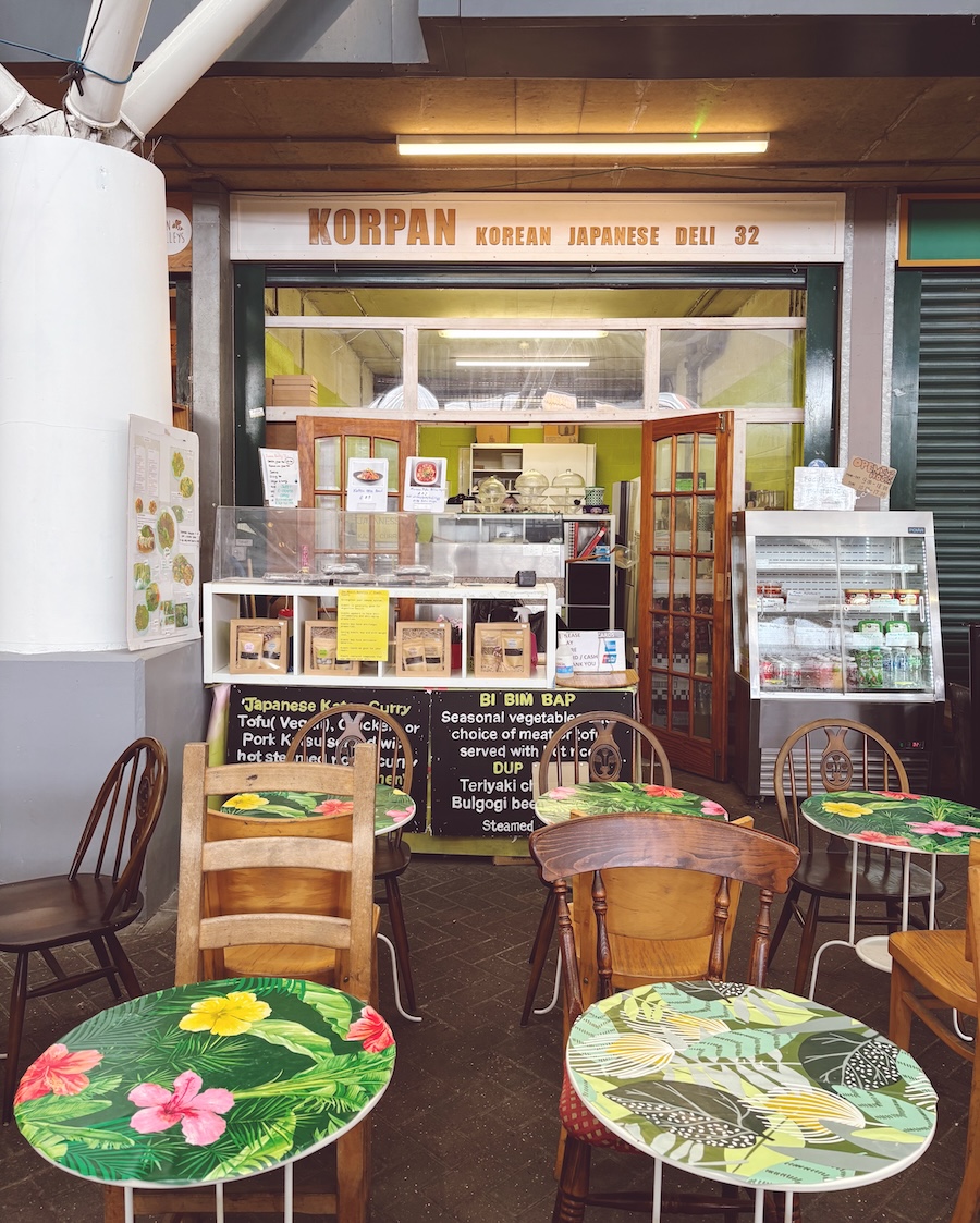 Korpan Korean and Japanese deli at Brighton Open Market with colourful cafe tables outside