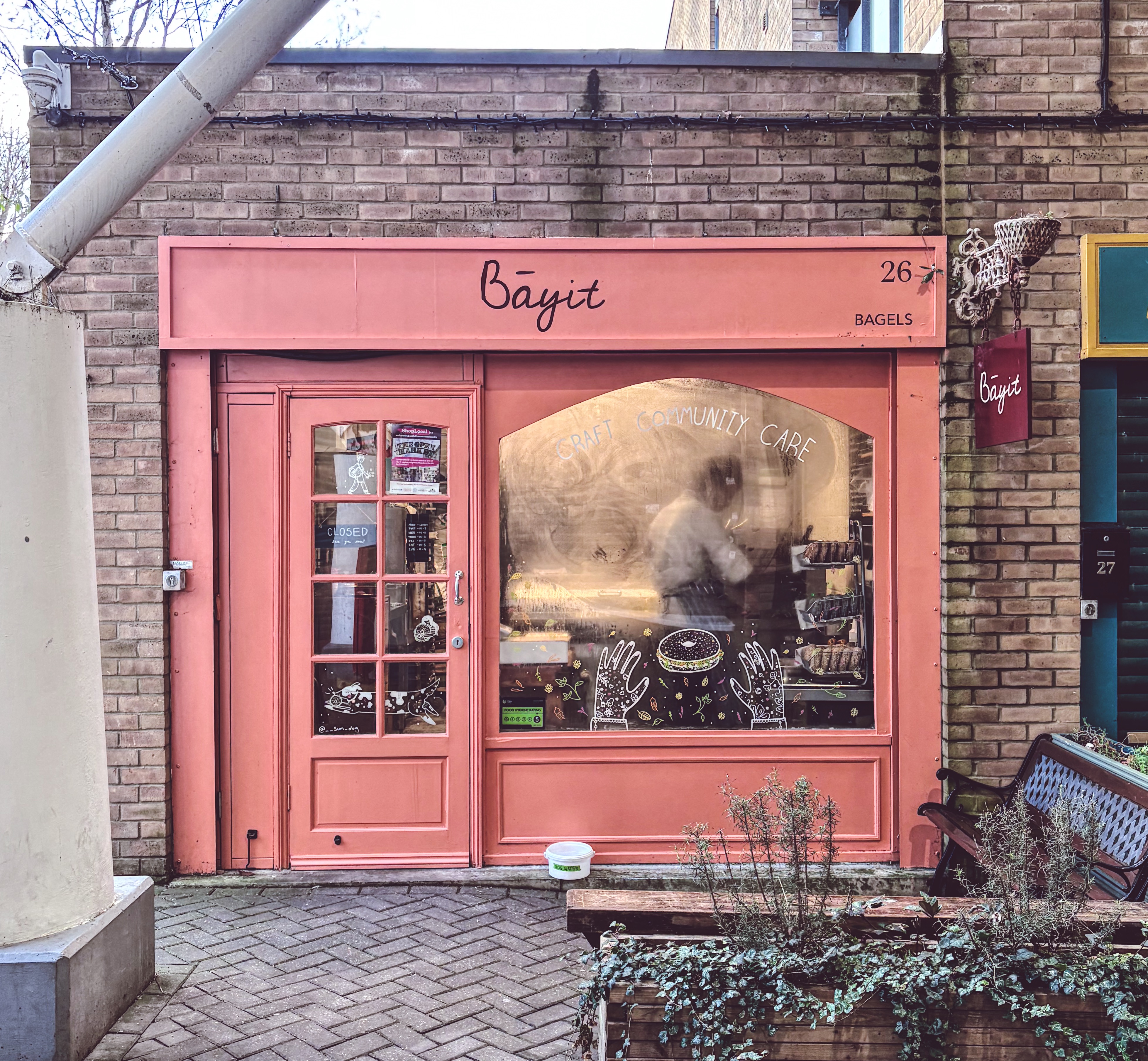 Pink shopfront of Bayit Bagels at Brighton Open Market