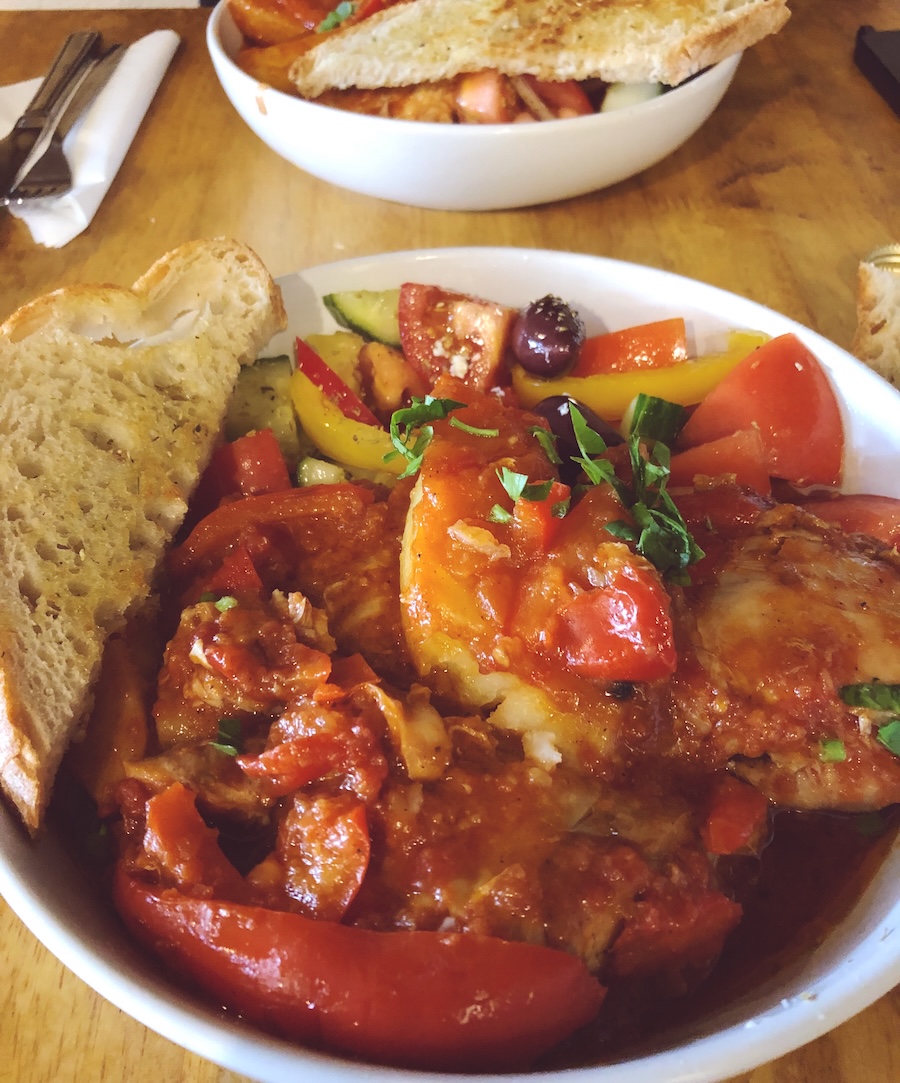 Greek-style baked dish with peppers, tomatoes, olives and bread at Brighton Open Market