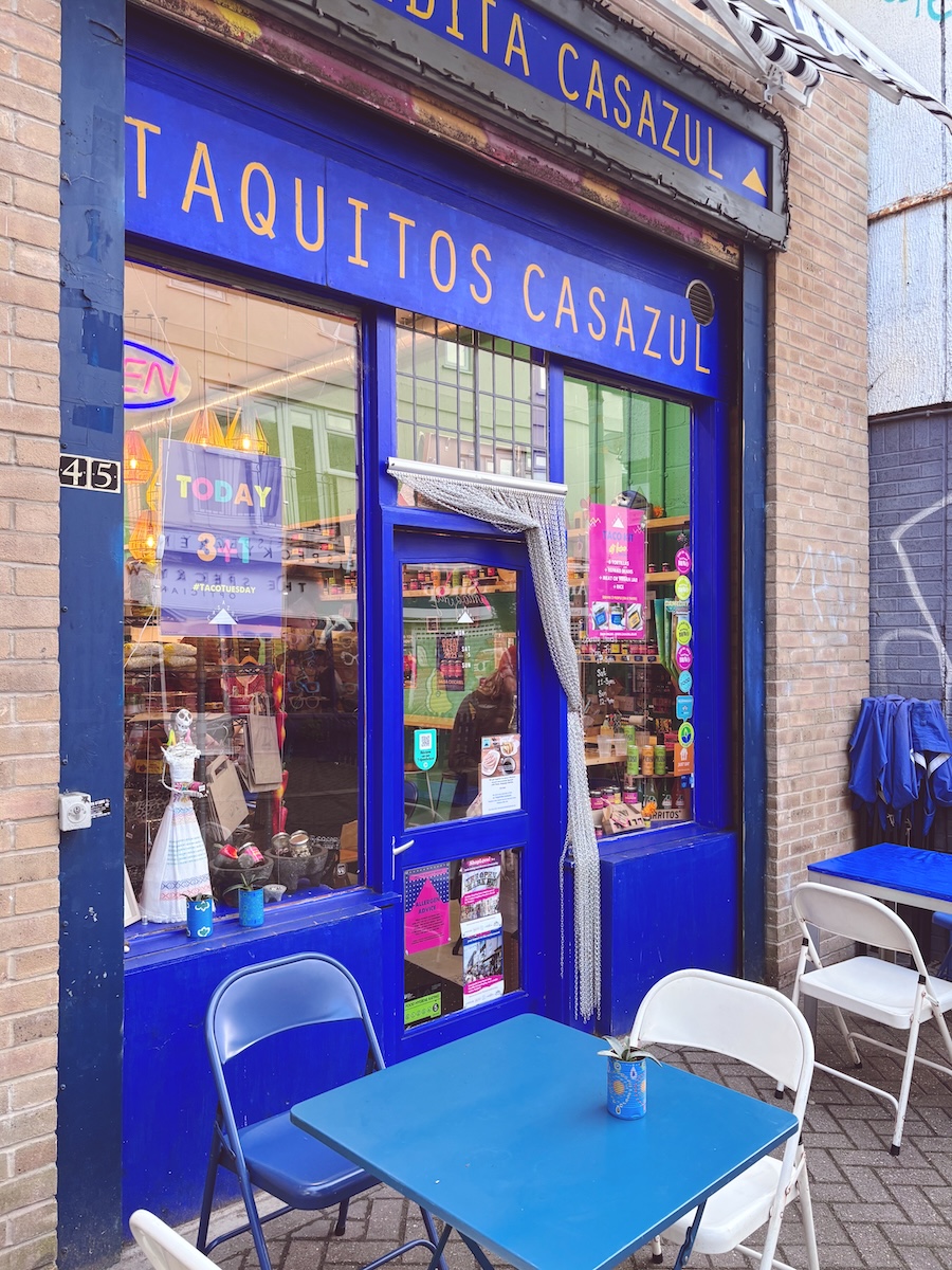 Bright blue Casa Azul taco shop at Brighton Open Market with outdoor tables