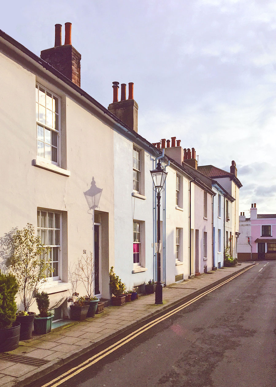 Pastel terraced houses on a quiet Brighton street